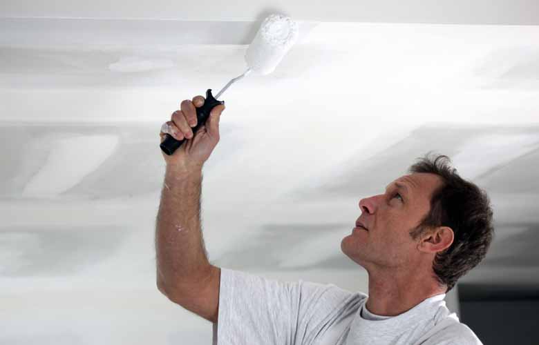 man painting ceiling