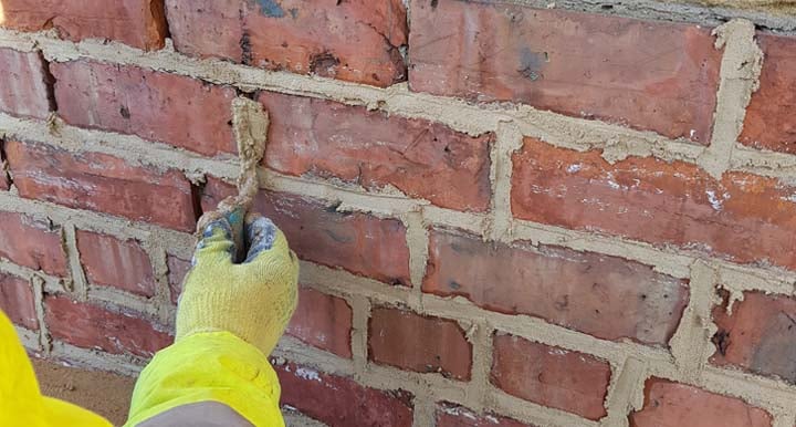 pointing a brick wall