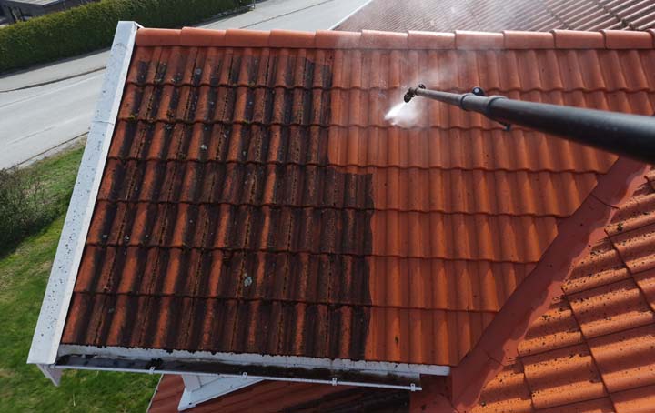 steam cleaning a tiled roof with a pressure washer
